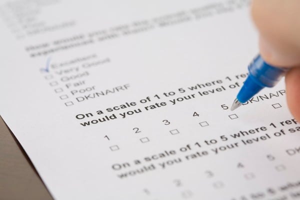 Questionnaire form being filled out with pen.