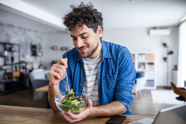 Happy Man Having a Nutritious Meal in Modern Kitchen