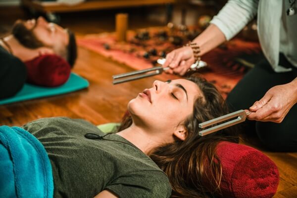 Tuning fork being used in sound therapy