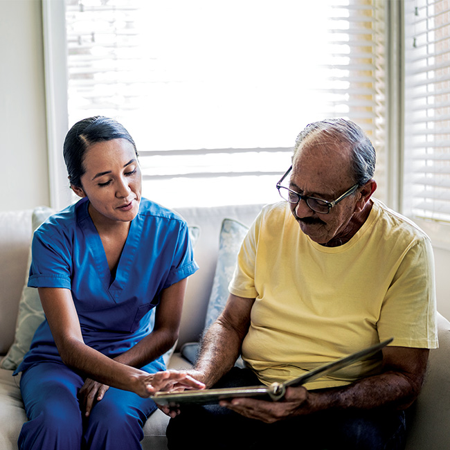 A man looking at a binder with a health professional