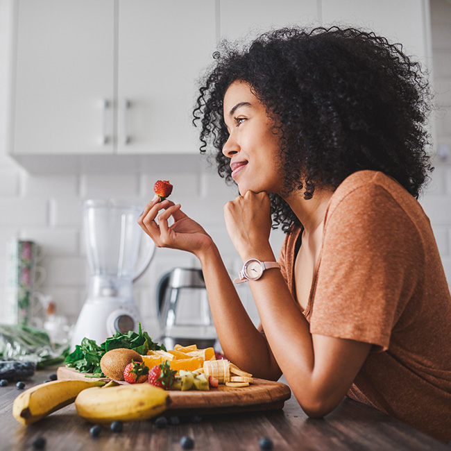A woman eating fruit