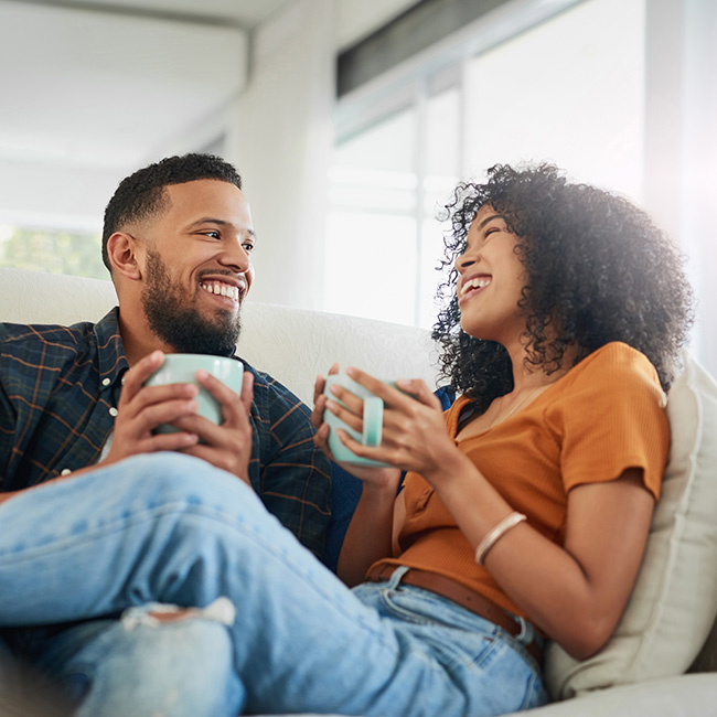 Two people in conversation on a couch
