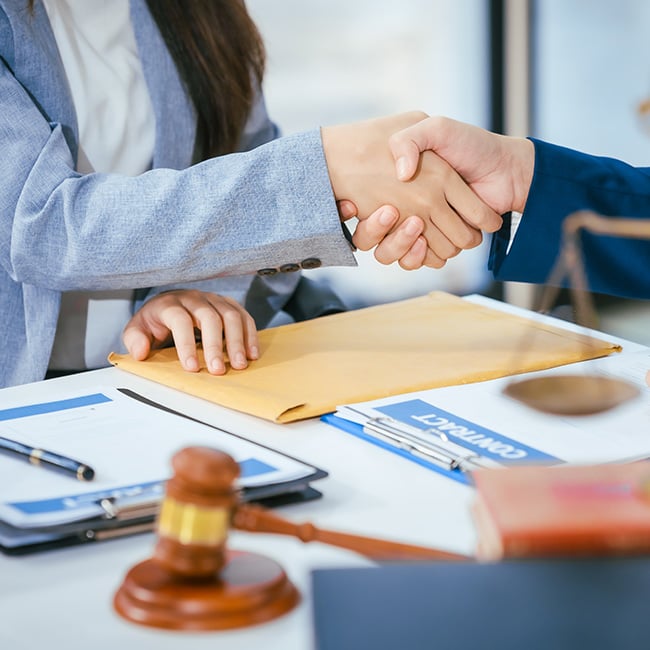 Hands shaking over a deal