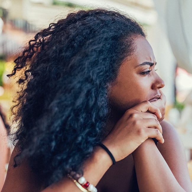 Woman looking off deep in thought.